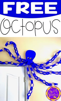 an octopus is hanging on the wall next to a door with a blue ribbon around it