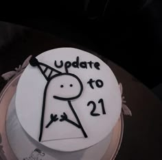 a white cake with the words update to 21 on it and a drawing of a person