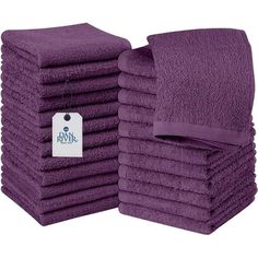 a stack of purple towels sitting next to each other