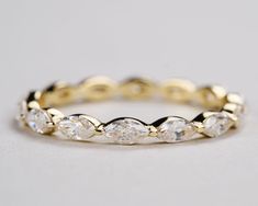 a yellow gold ring with five pear shaped diamonds