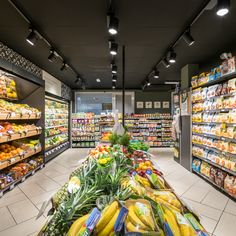 a grocery store filled with lots of fresh fruits and veggies in it's aisles