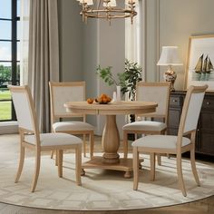 a dining room table with four chairs around it