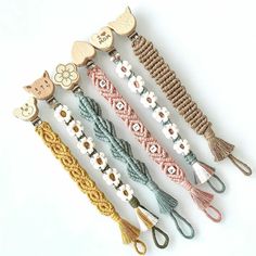 several different types of bracelets are lined up together on a white surface with scissors