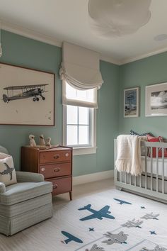 a baby's room with a crib, chair and dresser