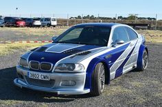 a blue and silver car parked in a parking lot