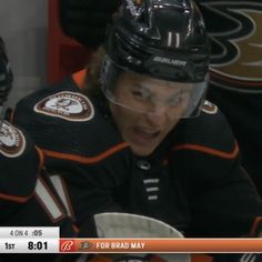 an image of a hockey player talking to someone on the sidelines in front of him