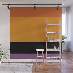 an orange, black and yellow wall mural in a living room