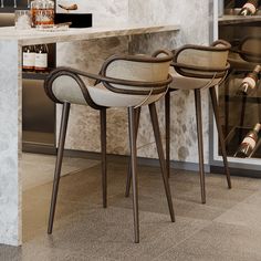 two chairs sitting next to each other in front of a counter with bottles on it