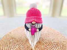 a small gnome figurine sitting on top of a mat