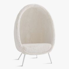 a white chair with an oval shaped cushion on it's back legs and footrests