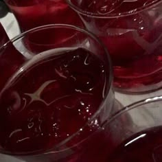 several glasses filled with liquid sitting on top of a table