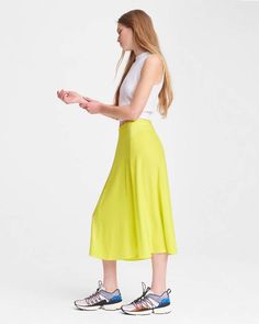 100% silk charmeuse, 100% of your standout looks. The Lucille skirt in lime green is an easy day-to-night midi for summer that will brighten up any warm-weather wardrobe. With a flattering a-line silhouette, it’s fitted at the waist and flares along the knee. Notice the mix of both matte and shine in the silk-among the many intricacies of this hand-selected fabric and expertly executed style. With an invisible zipper at the center back, the mixed-media detailing, and more, this midi takes detail Spring Silk A-line Maxi Skirt, Spring Silk A-line Skirt, Green A-line Maxi Skirt For Spring, Chic Summer A-line Maxi Skirt, Summer Viscose Maxi Skirt, Summer Viscose Flowy Maxi Skirt, Summer Flowy Viscose Maxi Skirt, Flowy Viscose Maxi Skirt For Summer, Summer Rayon Skirt With Relaxed Fit