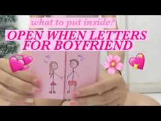 a woman holding a pink book with hearts on it and the words, what to put inside? open when letters for boyfriend