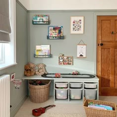 a playroom with toys and books on the shelves, along with other storage bins