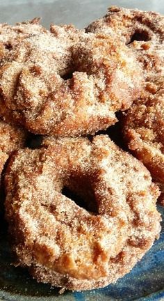 some sugared doughnuts are on a blue plate