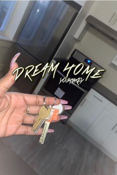 a person holding keys in their hand with the words dream home on it