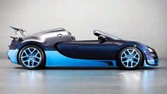 a blue and black sports car is parked in a room with grey walls, white flooring and shiny chrome rims