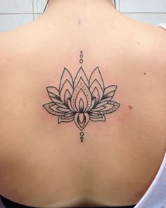 a woman with a lotus tattoo on her back