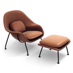 an egg chair and ottoman in brown leather