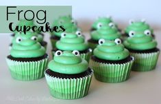 cupcakes with green frosting and googly eyes are arranged on a table