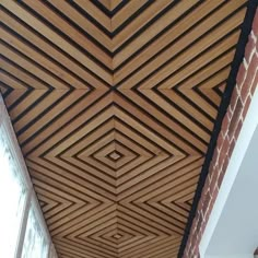 the ceiling is made out of wood and has an unusual design on it's side