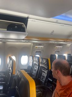 a man sitting in an airplane looking out the window