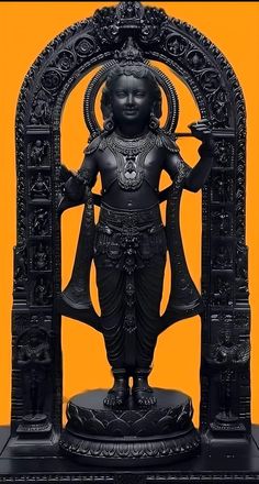 the statue is standing in front of an orange background with black accents and gold trimmings