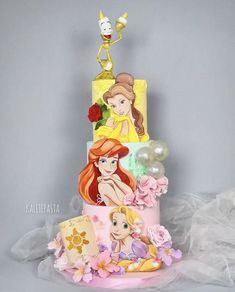 there is a three tiered cake with princesses on it