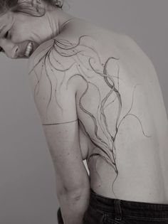 a woman with a tattoo on her back