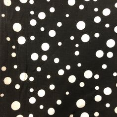 a black and white polka dot fabric with small white dots on the back of it