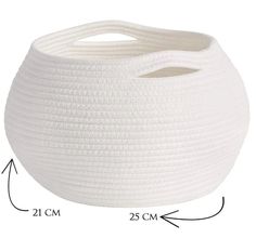 a large white basket sitting on top of a table next to a measuring tape measure