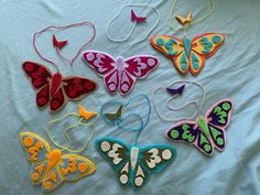 a group of colorful butterflies sitting on top of a white sheet