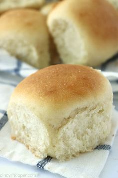 two rolls sitting on top of a blue and white checkered cloth