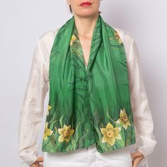 "Designer: Liga Kandele Material: 100% silk  fabric Colour: green and yellow. Size:  14.1\" X 53.5\"  ( 36 cm X  135 cm) Gift wrapped This green silk scarf is personally hand painted scarf by me and it's unique piece of art to wear.  I am professional silk painting artist with many years of experience. My studio is located in beautiful place near the Adriatic sea in Albania. This multi-purpose daffodils print scarf can be used to make any outfit stand out. There are so many ways to wear it like scarf or shawl, top, belt, bag scarf, hair scarf or head scarf, bandana or turban. Let your imagination fly. It can be perfect mindfulness gift for your loved ones. Great mother in law gift, daughter in law gift, gift for mom, aunt gift, 60th birthday gift, 50th birthday gift for women, cotton anniv Gold Silk Scarf For Spring, Green Silk Scarf For Formal Occasions, Formal Green Silk Scarf, Yellow Silk Scarf For Spring Gift, Yellow Silk Scarf For Spring, Personalized Scarves, 50th Birthday Gifts For Woman, Green Silk Scarf, Spring Scarf