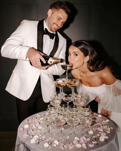 a bride and groom are pouring champagne into glasses