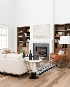 a living room filled with furniture and a fire place next to a bookcase full of books