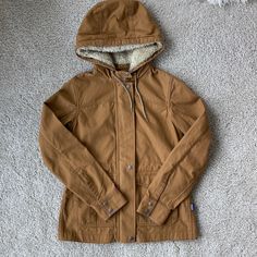 Discontinued And In Mint Condition! I Never Wore This But Adore It So Much. The ‘Bear Brown’ Color Is Rich And New. No Signs Of Wear. Sturdy And Rugged 8-Oz 100% Organic Cotton Canvas Is Offset By Soft 8.6-Oz 100% Polyester Fleece In The Hood And 4.9-Oz 100% Organic Cotton Twill Touch Points On The Inner Cuffs And Lining Center-Front Metal Zipper Is Hidden Under An Covered Placket With Metal Snap Closure Ample 3-Panel Hood Is Lined In Soft Cozy Polyester Fleece And Has A 3mm Climbing-Rope Drawco Bear Brown, Climbing Rope, Patagonia Jacket, Metal Zipper, Patagonia Womens, Utility Jacket, Hand Warmers, Patagonia, Brown Color