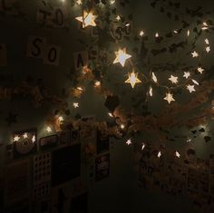 the lights are hanging from the ceiling in the room with pictures on it and stars above them