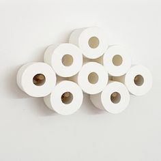 several rolls of white toilet paper stacked on top of each other with holes in the middle