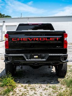 The tailgate of a blackout off-road 2022 Chevy Silverado with a red Chevrolet inlay Red Chevy Silverado, 2022 Chevy Silverado, Chevy Silverado 1500, Red Accents, Chevy Silverado, The Battle, Chevy Trucks, Off Road