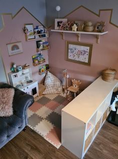 a child's room with pink walls and furniture