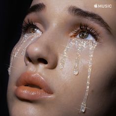 a woman's face is covered with water drops