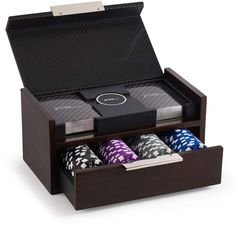 a wooden box with four poker chips in it and the lid opened to show its contents