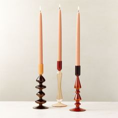 three candles sitting next to each other on top of a table