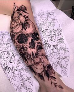 a skull and flowers tattoo on the leg by an artist in black and grey ink