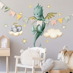 a child's room with a green dragon wall decal on the wall next to a white rocking chair