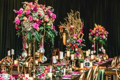 a table set up with flowers and candles for an elegant dinner or wedding reception in pinks, greens and golds