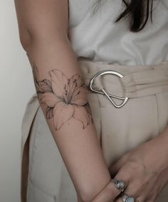 a woman with a flower tattoo on her arm