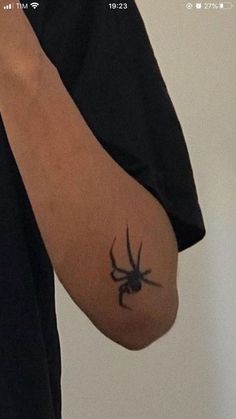 a person with a spider tattoo on their arm