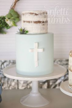 a cake with white frosting and a cross on top